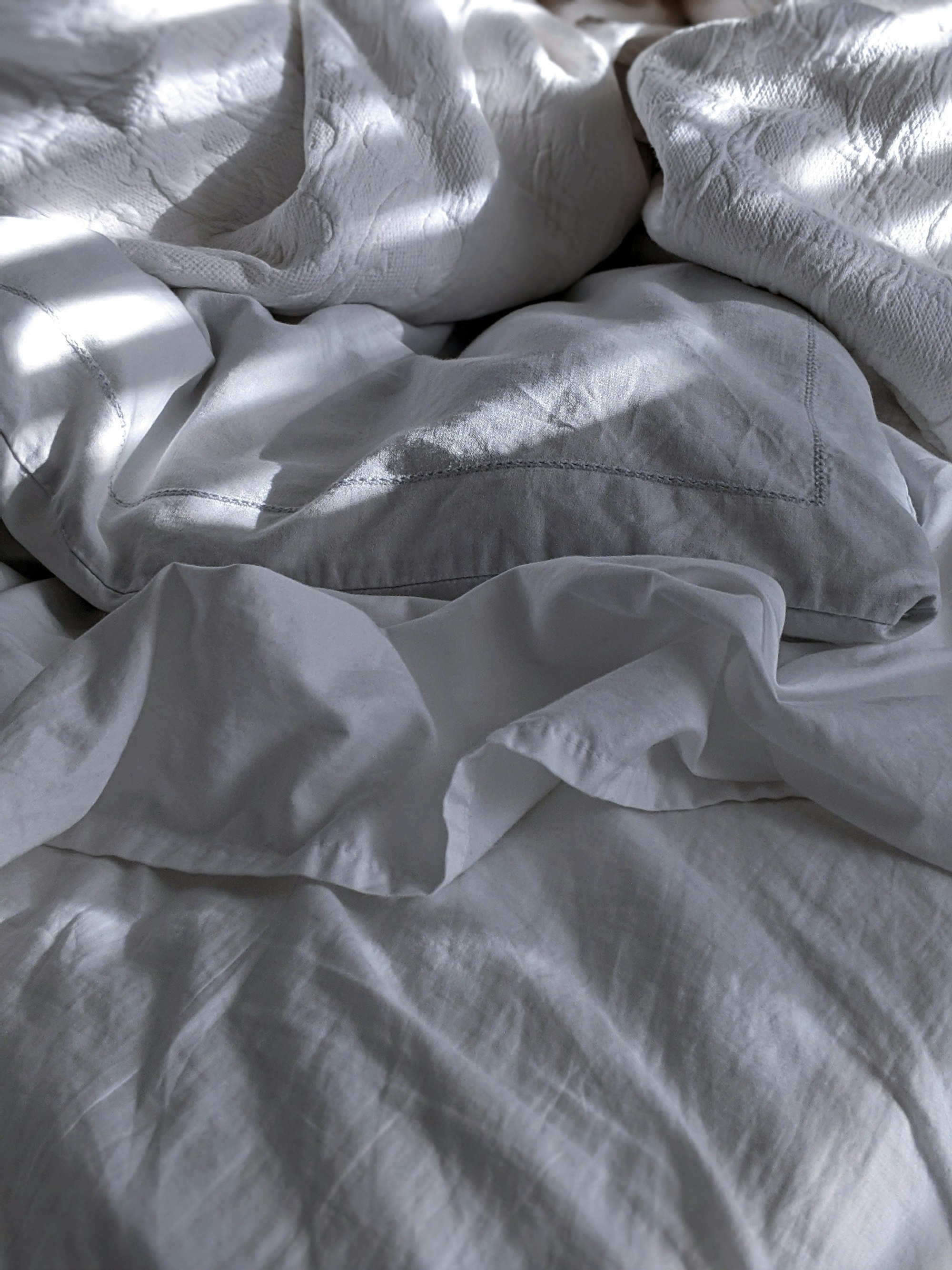 Crisp white linen bedding in a light-filled W1 residence